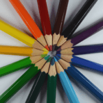 Colored pencils are facing one point and creating a circular shape