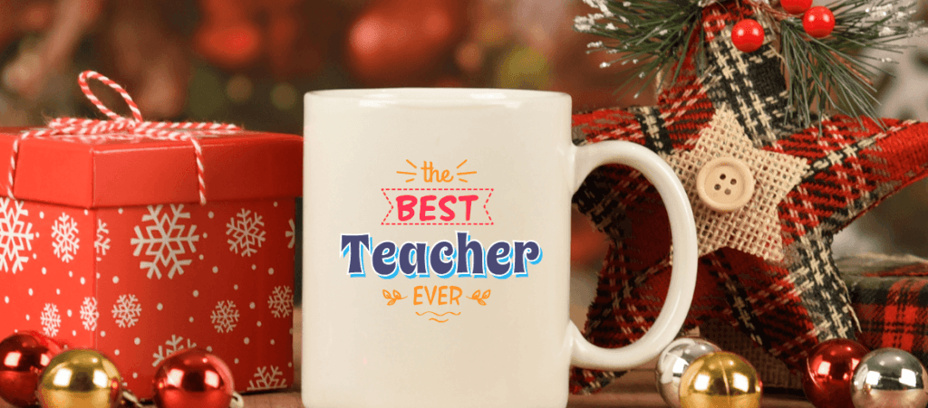 white coffee mug next to the gift box says Best Teacher Ever