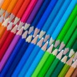 A row of colored pencils lined up in a row