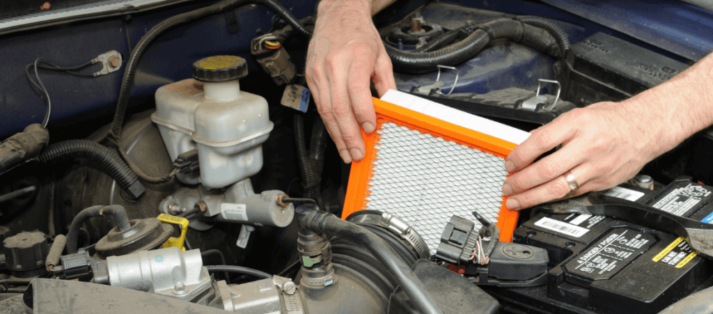 A mechanic changing the engine air filter